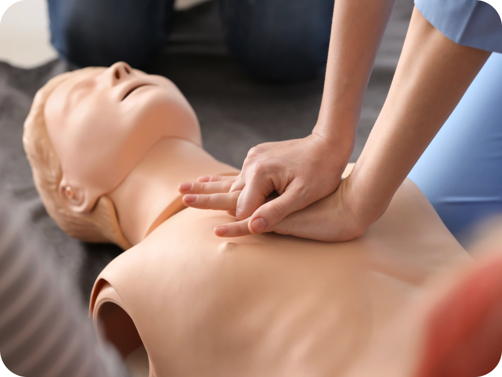 A person performing CPR on a medical training mannequin